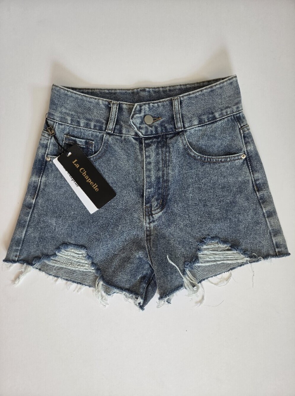 La Chapelle medium wash distressed denim shorts with a raw cutoff hem sz S/27